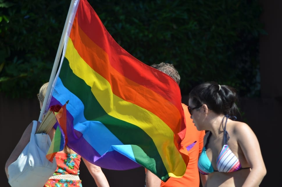 Woman In Red And Blue Floral Dress Holding Lgbt Flag - Pride Parade - HD Wallpaper 