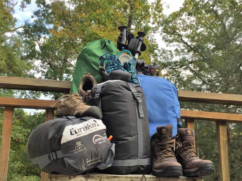 Camping And Hiking Gear Piled Up On A Deck - HD Wallpaper 