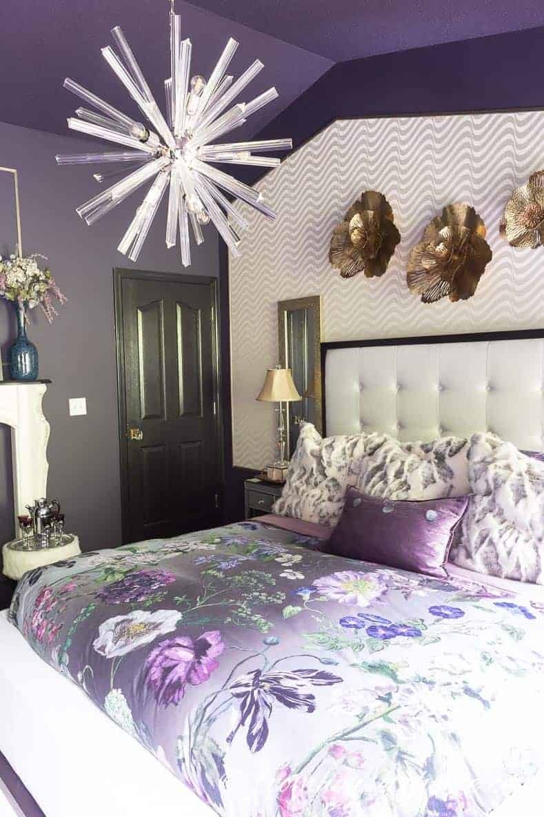 The White Wallpaper Behind The Bed Helps To Brighten Purple And White