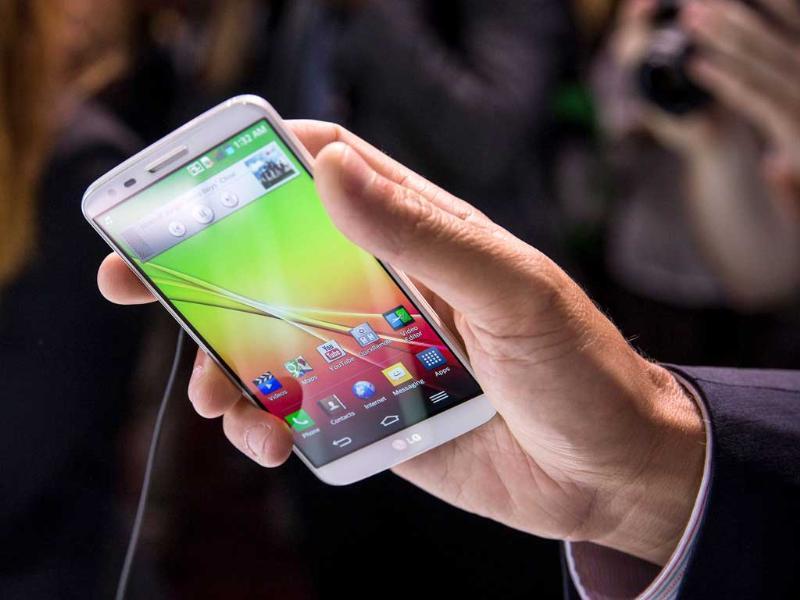 A Man Looks At The Lg G2 Smartphone At The Phone S - Lg Con Botones Laterales - HD Wallpaper 