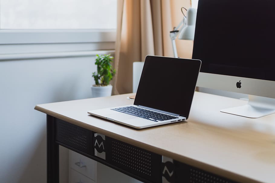 Silver Laptop On Desk Beside Silver Imac, Macbook On - Laptop On A Table Png - HD Wallpaper 
