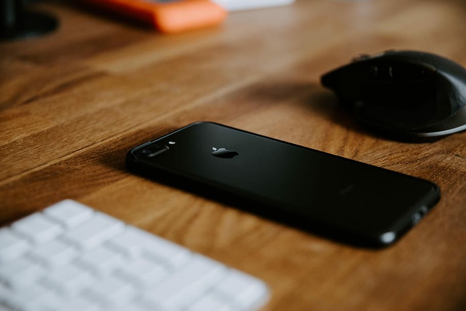 Black Iphone 7 Plus On Brown Wooden Table Near Black - HD Wallpaper 