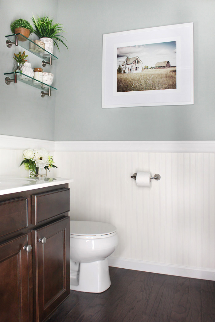 A Small Bathroom With Wallpaper And A Picture On The - Bathroom - HD Wallpaper 