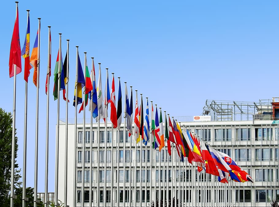Line Of Assorted-color Flags Beside White Concrete - Eu Countries Flag Poles - HD Wallpaper 