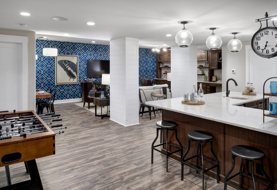 Luxury Finished Basement With Wallpapered Accent Wall Interior Design