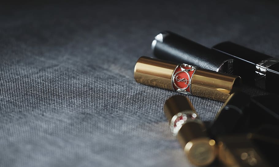 Lipsticks On Gray Panel, Two Gold And Black Metal Tools, - Lipstick - HD Wallpaper 