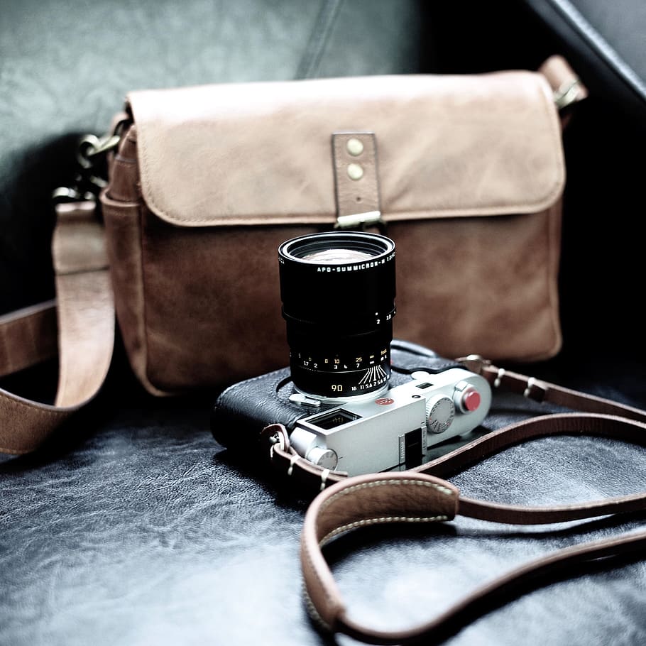 Gray And Black Dslr Camera Beside Brown Leather Sling - Digital Camera - HD Wallpaper 