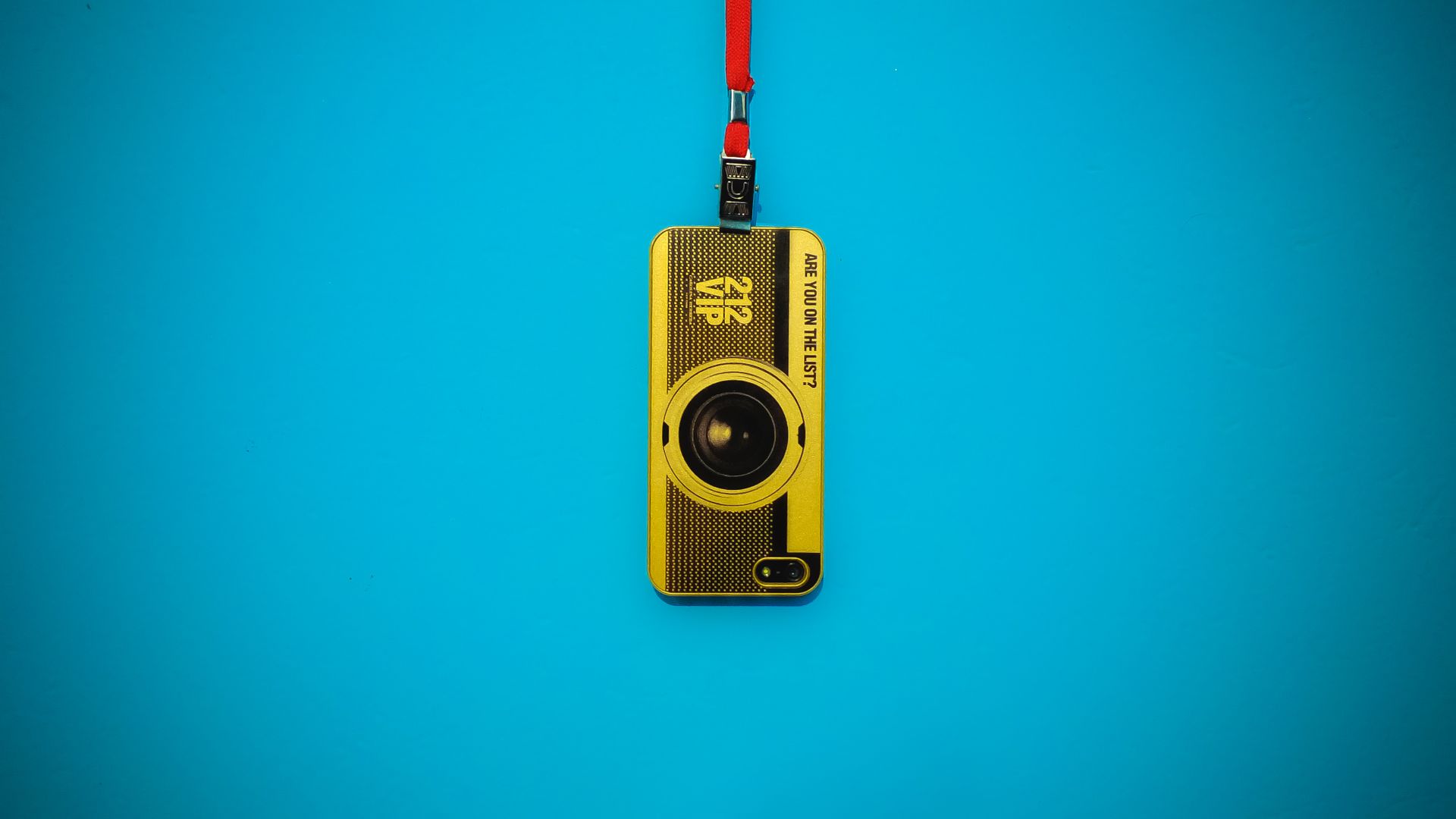 Yellow 212 Vip Camera Hanging On Blue Wall - Feature Phone - HD Wallpaper 