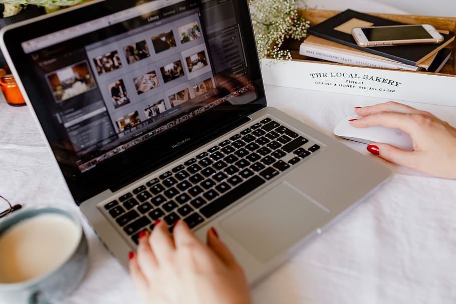 A Woman Works At A Desk With A Laptop And A Cup Of - Macbook Pro - HD Wallpaper 