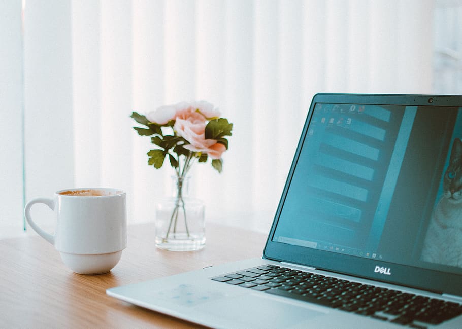 Black And Gray Dell Laptop Beside White Ceramic Mug - Laptop On Desk And Coffee Flower - HD Wallpaper 