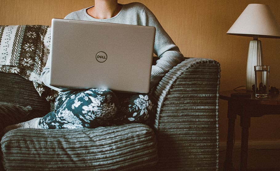 Person Using Dell Laptop While Sitting On Sofa Inside - Sitting - HD Wallpaper 